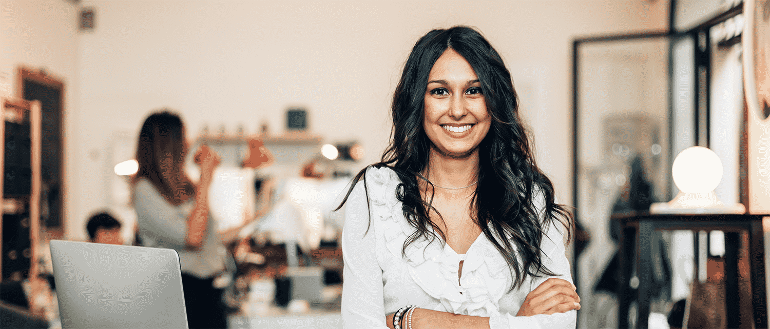 Smiling woman standing in a small, modern office space